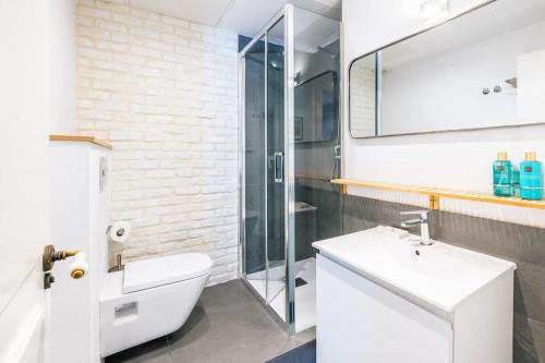 a bathroom with a toilet and a sink and a shower at Amazing flat 5 balconies in Chueca - Gran Via in Madrid