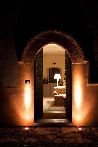 an archway leading into a living room at night at Castello di Gabiano in Gabiano