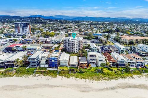 an aerial view of the beach and buildings at Beach Palms Holiday Apartments in Gold Coast