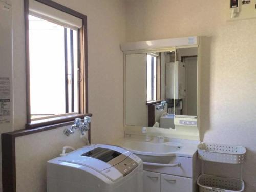 a bathroom with a sink and a washing machine at Second house TOYA / Vacation STAY 291 in Lake Toya