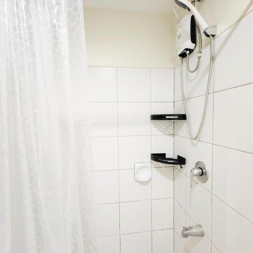 a bathroom with a shower with a shower curtain at eutz condominium daily rental in Cebu City