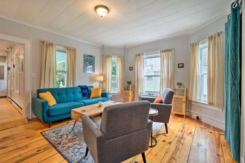 a living room with a blue couch and chairs at Updated Vintage Apartment Less Than half Mi to Main St in Keene