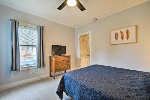 a bedroom with a bed and a tv and a window at Updated Vintage Apartment Less Than half Mi to Main St in Keene