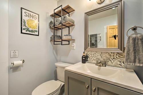y baño con aseo, lavabo y espejo. en Updated Vintage Apartment Less Than half Mi to Main St, en Keene