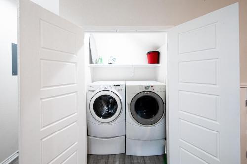 a white laundry room with a washer and dryer at Lakeshore Retreat in Canyon Lake