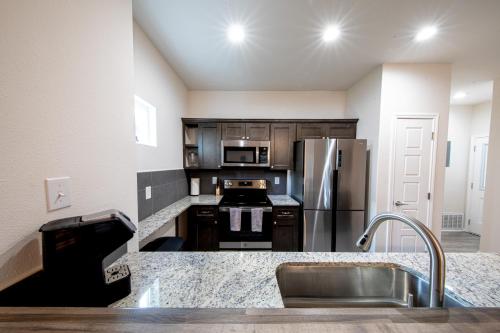 a kitchen with a stainless steel refrigerator and a sink at Lakeshore Retreat in Canyon Lake