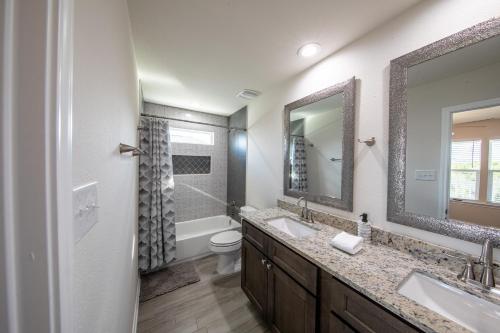 a bathroom with two sinks and a toilet at Lakeshore Retreat in Canyon Lake