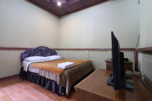Postel nebo postele na pokoji v ubytování Kampung Pa'go Resort Hotel