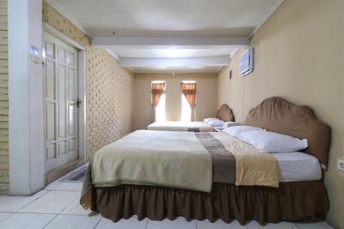 Postel nebo postele na pokoji v ubytování Kampung Pa'go Resort Hotel