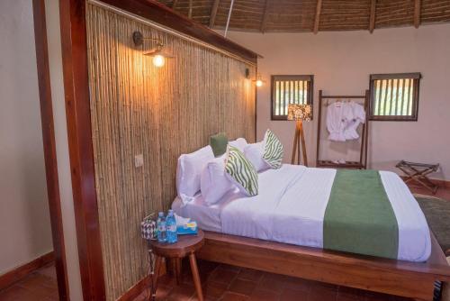 a bedroom with a large bed in a room at Tilenga Safari Lodge in Arua