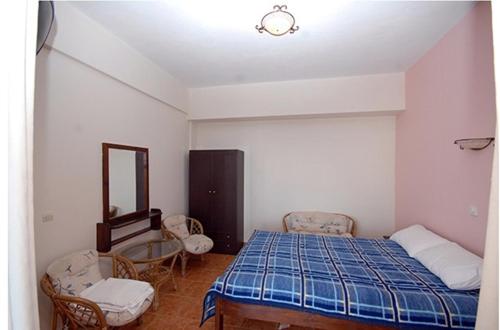 a bedroom with a bed and a table and chairs at Porto Kalliali in Ouranoupoli