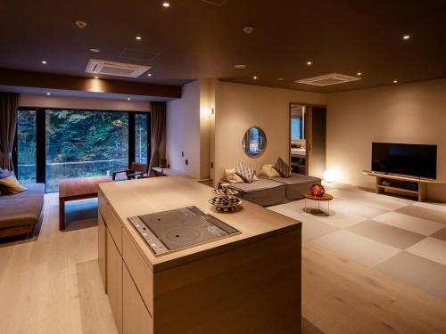 a large living room with a couch and a tv at Hakkei in Maniwa