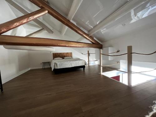 a bedroom with a bed in a room with wooden beams at NIMES Superbe appartement duplex climatisée in Nîmes