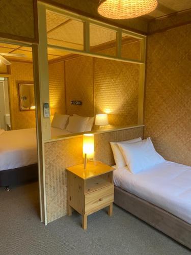 Ένα ή περισσότερα κρεβάτια σε δωμάτιο στο Tallow Beach Motel