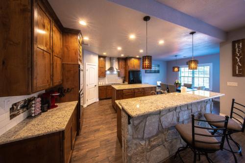 a large kitchen with a large stone counter top at Lakeview Luxury in Canyon Lake