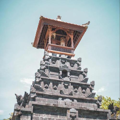 a tall tower with people sitting on top of it at PIMA Homestay in Pesanggaran