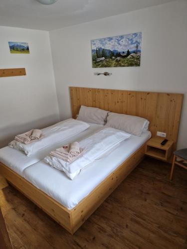 a bed in a room with two towels on it at Gasthof Post in Mittersill