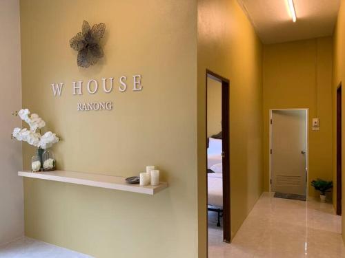 a room with a whosoke dancing sign on the wall at W House Ranong 1 Bedroom villa 8/10 in Ban Lum Than