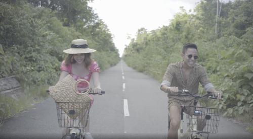 a man and a woman riding bikes down a road at Arasatu Villas & Sanctuary in Maratua Atoll
