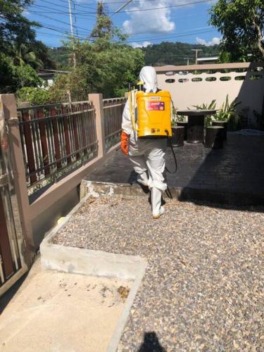 a man walking up the stairs of a house at W House Ranong 2Bedroom villa 8/10 in Ban Lum Than
