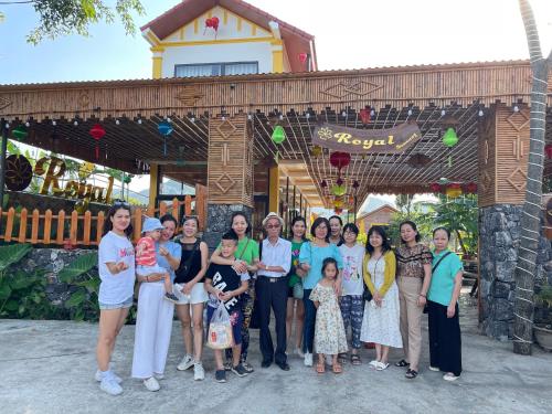 a group of people posing for a picture in front of a building at Ninh Binh Royal Homestay in Ninh Binh