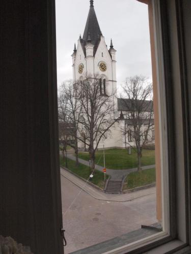 a window view of a church with a clock tower at Nora Stadshotell, Sure Hotel Collection by Best Western in Nora