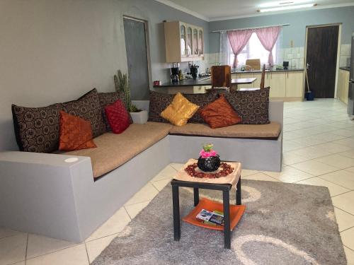 a living room with a couch and a table at Daffodil self catering and accommodation A in Swakopmund