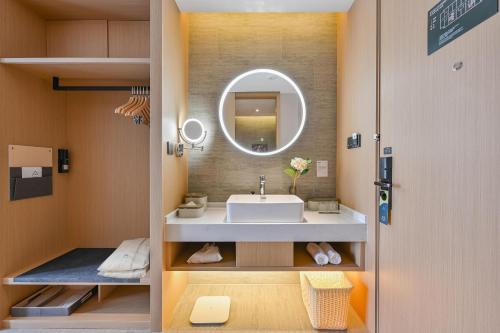 a bathroom with a sink and a mirror at Atour Hotel Shanghai Songjiang Sports Center in Shanghai