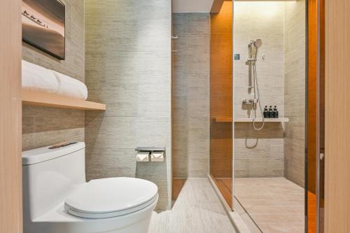 a bathroom with a toilet and a shower at Atour Hotel Shanghai Songjiang Sports Center in Shanghai