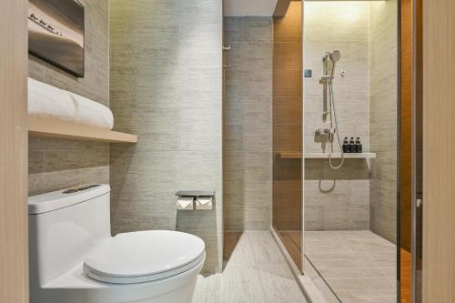 a bathroom with a toilet and a shower at Atour Hotel Shanghai Songjiang Sports Center in Shanghai