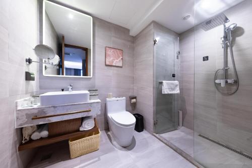 a bathroom with a sink toilet and a shower at Atour X Hotel Yantai Penglai Pavilion in Penglai