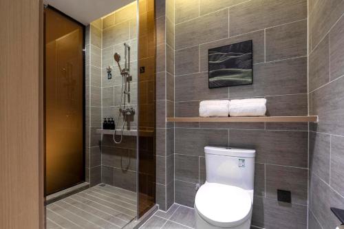 a bathroom with a toilet and a shower at Atour Hotel Wuhan Guanshan Avenue Guanggu Software Park in Wuhan