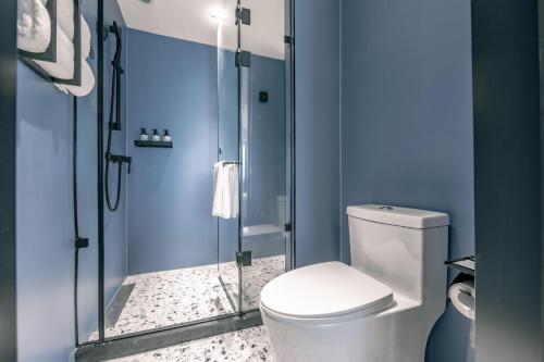 a bathroom with a toilet and a glass shower at Atour Light Zhengzhou West Longhai Road Subway Station in Zhengzhou
