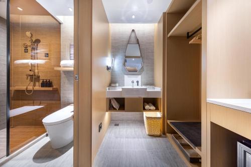 a bathroom with a toilet and a sink at Atour Hotel Bohai International Plaza Binzhou in Binzhou