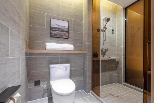a bathroom with a toilet and a shower at Atour Hotel Wuhan Guanshan Avenue Guanggu Software Park in Wuhan