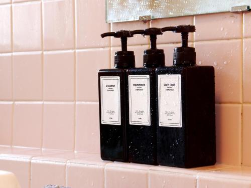 two bottles of soap sitting on a counter in a bathroom at 富山県 よしのや旅館 in Nanto