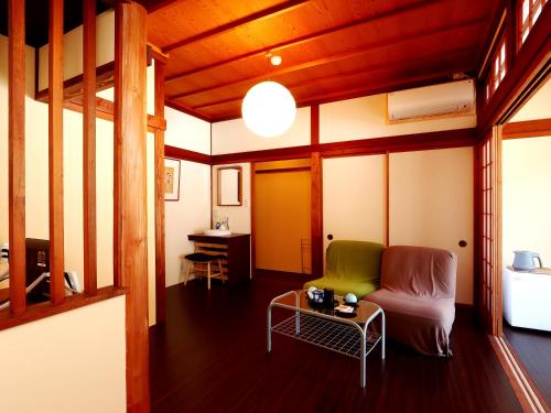 a living room with a couch and a table at 富山県 よしのや旅館 in Nanto