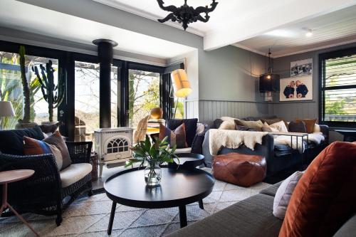 a living room with a couch and a table at Harts Lane Haus- outdoor entertainer, pet friendly in Daylesford