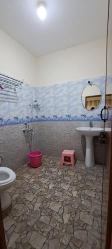 a bathroom with a sink and a toilet at Ghar - Homestay, Where Family Lives Together in Aruvankadu