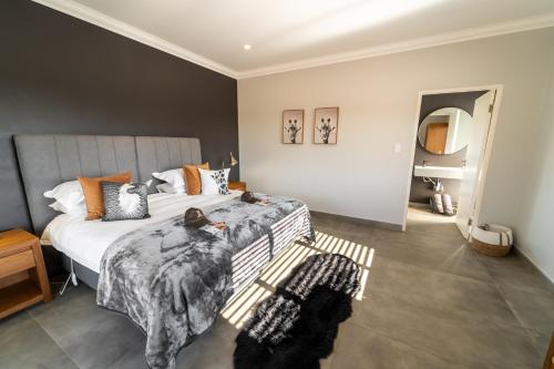 a bedroom with a bed with a blanket on it at Leeuwkop Hunting Safaris in Kimberley