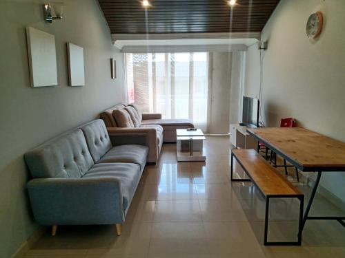 a living room with a couch and a table at HOMY APARTAMENTOS #8 - Apt Grande G12 Agora Corferias embassy UN in Bogotá