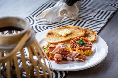 a plate of food with a sandwich and toast at Leeuwkop Hunting Safaris in Kimberley