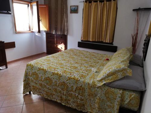 a bedroom with a bed and a dresser and a window at La casina di Assisi in Assisi