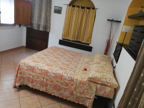 a bedroom with a bed and a mirror in it at La casina di Assisi in Assisi
