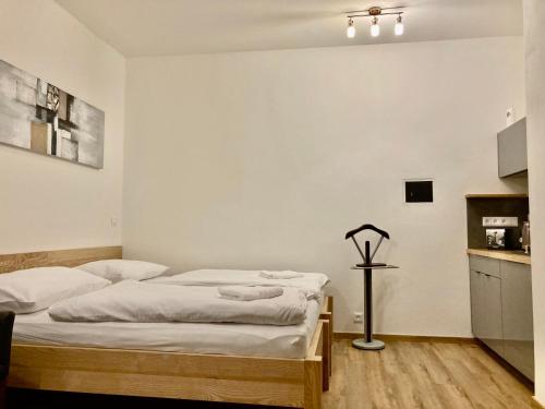 a bedroom with two beds and a table in it at Tilia apartments Březová in Březová