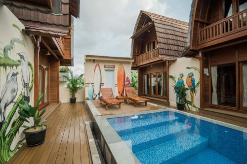 a house with a swimming pool in the backyard at Andi Beach House in Canggu