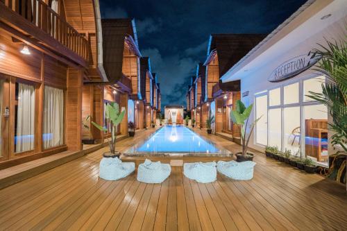 a building with a pool in the middle of a street at Andi Beach House in Canggu