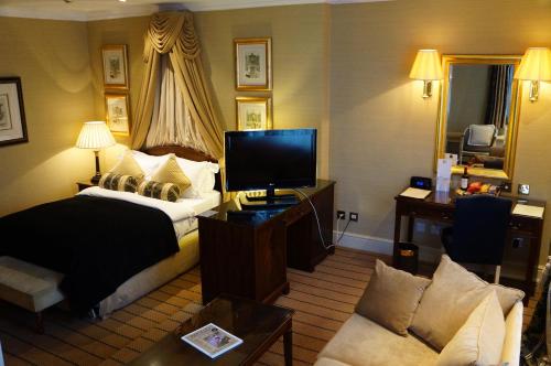 a hotel room with a bed and a television at The Colonnade in London