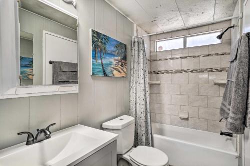 a white bathroom with a sink and a toilet at Bullhead City Home Close to Laughlin Casinos! in Bullhead City