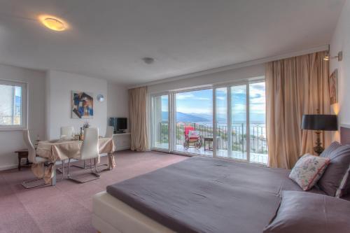 a living room with a couch and a large window at Apartments Villa Manda in Novi Vinodolski